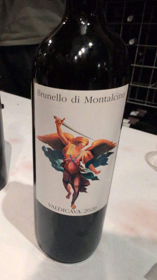 A bottle of Valdicava Brunello di Montalcino 2020, its label showing a painted archangel holding a raised sword