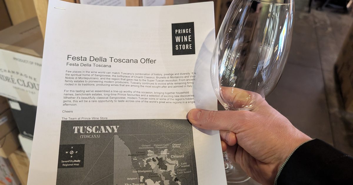 The Festa della Toscana offer sheet from Prince Wine Store, held beside an empty tasting glass