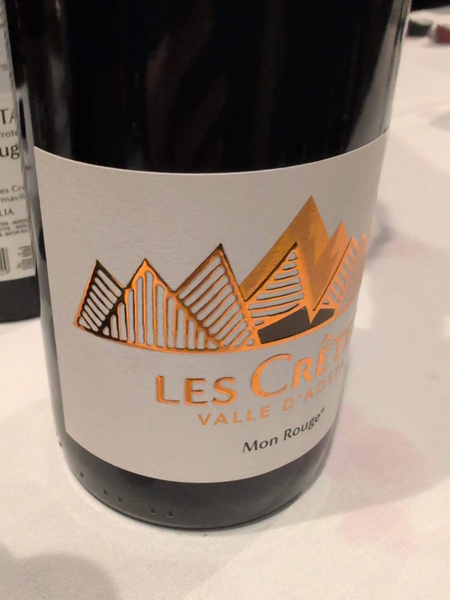The Les Crêtes Mon Rouge bottle, its pale label carrying a copper mountain-range illustration above the words Les Crêtes, Valle d'Aosta